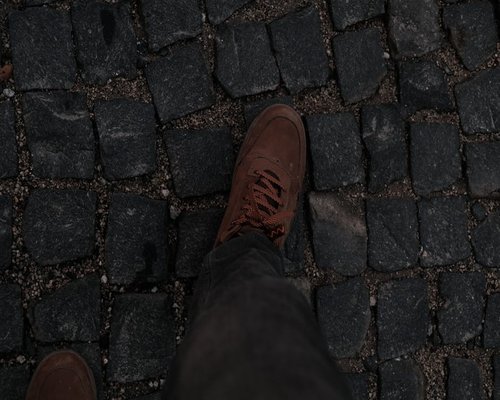 Comfortable shoes stepping on a cobblestone street