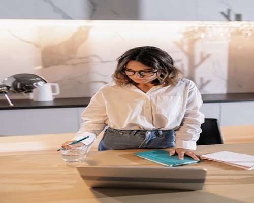 Person standing up from their desk to take a short break